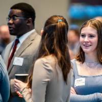 Students conversing at the West Michigan Economic Forecast